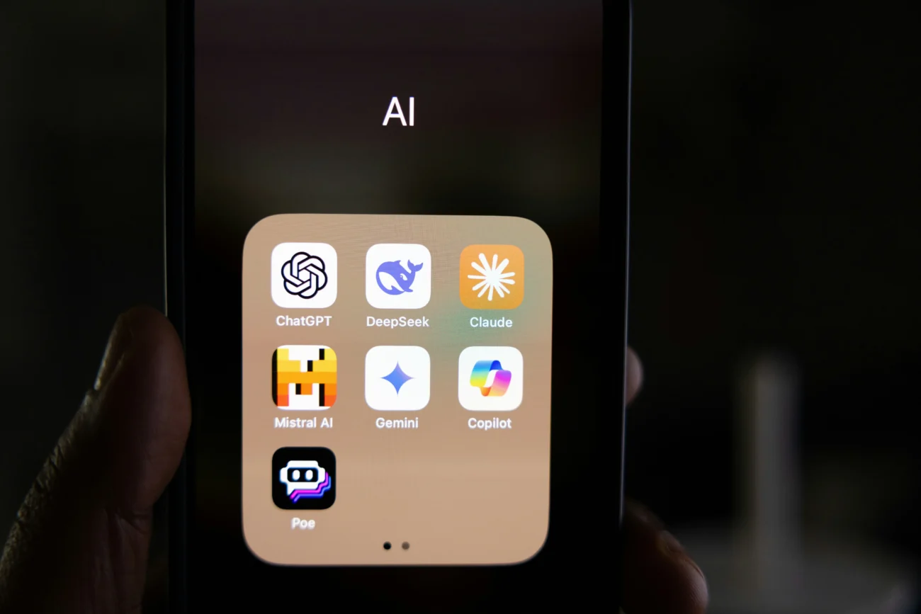 Best AI tools for content creators in 2026 — smartphone showing ChatGPT, Claude, Gemini, DeepSeek and Copilot AI apps
